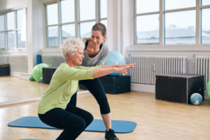 physical therapist working out with a senior woman